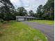 Exterior view of the house showcasing the driveway, lawn and welcoming front porch at 446 Westbrook Rd, Carrollton, GA 30116