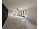 Large living room with black accent wall, a ceiling fan and back patio access at 446 Westbrook Rd, Carrollton, GA 30116