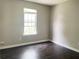 This bedroom has a large window and dark wood floors at 5465 Twin Lakes Dr, College Park, GA 30349