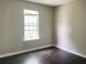 This bedroom has a large window and dark wood floors at 5465 Twin Lakes Dr, College Park, GA 30349