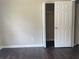 Bedroom features a closet, dark wood floors, and neutral paint at 5465 Twin Lakes Dr, College Park, GA 30349