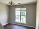 Intimate dining area featuring hardwood floors, a modern chandelier, and abundant natural light at 5465 Twin Lakes Dr, College Park, GA 30349