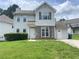 Traditional two-story home boasts a well-manicured lawn, brick accents, and classic window shutters at 5465 Twin Lakes Dr, College Park, GA 30349
