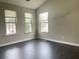 Living room offers three windows and dark wood floors at 5465 Twin Lakes Dr, College Park, GA 30349