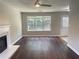 Bright living room with fireplace, wood floors, and an open layout to the backyard at 5465 Twin Lakes Dr, College Park, GA 30349