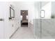 Bathroom with a glass shower, white cabinets, double vanity, tub, and marble floors at 621 Silva St # 124, Cumming, GA 30040