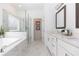 Modern bathroom with dual vanity sinks, frameless glass shower, and a soaking tub for relaxing at 621 Silva St # 124, Cumming, GA 30040