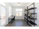 Cozy office space featuring a desk, shelving unit, and a window allowing plenty of natural light at 621 Silva St # 124, Cumming, GA 30040