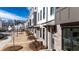 Street-level view of new townhomes featuring brick exteriors, individual entrances, and mature landscaping at 621 Silva St # 124, Cumming, GA 30040
