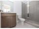 Clean bathroom features a shower with glass doors, a gray vanity, and a white toilet at 629 Silva St # 128, Cumming, GA 30040
