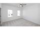 Neutral bedroom with two windows bringing in natural light and plush carpet at 629 Silva St # 128, Cumming, GA 30040