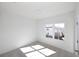 Bright, empty bedroom with plush carpet and a window overlooking the neighborhood at 629 Silva St # 128, Cumming, GA 30040