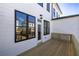 Private wooden deck with views of neighboring homes and blue skies at 629 Silva St # 128, Cumming, GA 30040