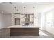 Bright modern kitchen with a large island, white cabinetry, and stainless steel appliances at 629 Silva St # 128, Cumming, GA 30040
