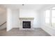 Spacious living room featuring a stone fireplace, large windows, and gray hardwood floors at 629 Silva St # 128, Cumming, GA 30040