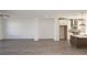Open-concept with grey flooring connecting living space to modern kitchen with stainless hood at 629 Silva St # 128, Cumming, GA 30040