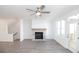 Light-filled living room with a modern fireplace, ceiling fan and hardwood floors at 629 Silva St # 128, Cumming, GA 30040
