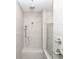 Bright shower with tile walls, a built in seat, and a rainfall shower head at 629 Silva St # 128, Cumming, GA 30040