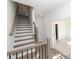 Bright entryway with elegant wooden staircase and access to a carpeted room at 629 Silva St # 128, Cumming, GA 30040