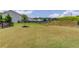 View of the spacious backyard featuring a black fence, grassy lawn, and some landscaping at 4035 Starwood Dr, Cumming, GA 30028