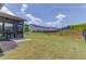View of the spacious backyard featuring a black fence, grassy lawn, and some landscaping at 4035 Starwood Dr, Cumming, GA 30028