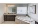 Bright bathroom with soaking tub and dark brown cabinets at 4035 Starwood Dr, Cumming, GA 30028