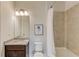 Tiled bathroom with a shower-tub combo, granite countertop, and modern fixtures at 4035 Starwood Dr, Cumming, GA 30028