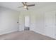 Neutral bedroom with multiple closets and a ceiling fan at 4035 Starwood Dr, Cumming, GA 30028