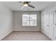 Bedroom featuring neutral carpet, a ceiling fan, and a window at 4035 Starwood Dr, Cumming, GA 30028