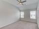 Bedroom featuring neutral carpet, a ceiling fan, and dual windows at 4035 Starwood Dr, Cumming, GA 30028