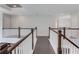 Second floor hallway with hardwood floors and dark wood handrails at 4035 Starwood Dr, Cumming, GA 30028