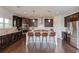 Modern kitchen featuring dark wood cabinets, a large center island, and stainless steel appliances at 4035 Starwood Dr, Cumming, GA 30028