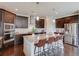 Stylish kitchen with dark wood cabinetry, granite countertops, and a stainless steel refrigerator at 4035 Starwood Dr, Cumming, GA 30028