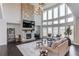 Bright living room with a stone fireplace, soaring windows, and hardwood floors at 4035 Starwood Dr, Cumming, GA 30028