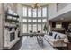 Spacious living room featuring a stone fireplace, large windows, and hardwood floors at 4035 Starwood Dr, Cumming, GA 30028