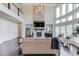 Open-concept living area with a stone fireplace, tall windows, and dark hardwood floors at 4035 Starwood Dr, Cumming, GA 30028