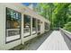 Spacious back porch with large windows showcasing natural light and views of the surrounding landscape at 4528 Lashley Ne Ct, Marietta, GA 30068