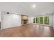 Basement Gathering room features a stone fireplace, built-in shelves, and wood-look flooring at 4528 Lashley Ne Ct, Marietta, GA 30068