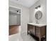 Bathroom with a wood vanity with drawers and a round mirror, with a view into the Primary bedroom at 4528 Lashley Ne Ct, Marietta, GA 30068