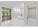 A modern bathroom features a sleek soaking tub, bright recessed lights, and stylish tile flooring at 4528 Lashley Ne Ct, Marietta, GA 30068