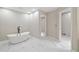 A modern bathroom features a sleek soaking tub, bright recessed lights, and stylish tile flooring at 4528 Lashley Ne Ct, Marietta, GA 30068