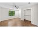 Bedroom with hardwood floors, neutral walls, a closet, and a window view of the outdoor landscaping at 4528 Lashley Ne Ct, Marietta, GA 30068
