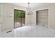 Bright kitchen dining area with modern chandelier, closet space, and deck access at 4528 Lashley Ne Ct, Marietta, GA 30068