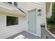 Close up of a home's side entrance featuring a light blue door and grey deck at 4528 Lashley Ne Ct, Marietta, GA 30068
