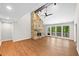 Open-concept living room featuring wood floors, stone fireplace, and large windows at 4528 Lashley Ne Ct, Marietta, GA 30068