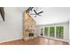 Bright living room featuring a striking stone fireplace, open floor plan, and wood floors at 4528 Lashley Ne Ct, Marietta, GA 30068