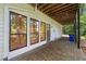 Covered patio features a concrete tile floor, large windows, and wood ceiling at 4528 Lashley Ne Ct, Marietta, GA 30068
