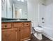Cozy bathroom with wood vanity, green countertops, and shower-tub combo at 520 White Pines Dr, Dallas, GA 30157
