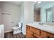 Full bathroom with a wood vanity, a large mirror, and combo shower and tub at 520 White Pines Dr, Dallas, GA 30157