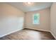 This bedroom features wood-look floors, neutral walls, and a window for natural light at 520 White Pines Dr, Dallas, GA 30157